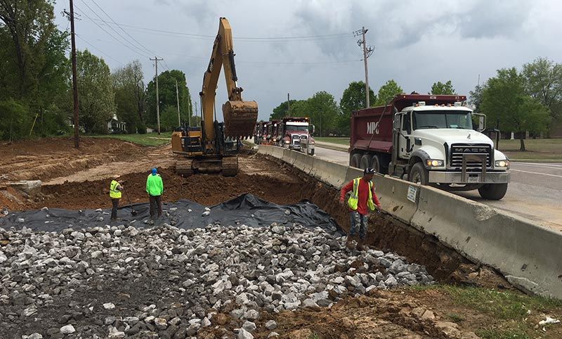 Leveling and placing granite for road expansion