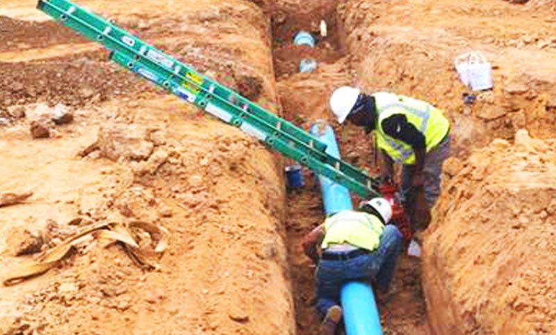 closeup photo showing construction of water distribution line installation